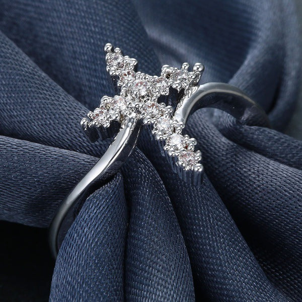 Close-up view of diamond-set cross motif on copper ring band