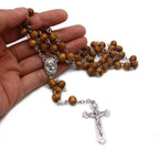 Red wooden bead rosary for Catholic prayer and daily devotion