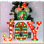 Illuminated JOY Christmas letters glowing warmly