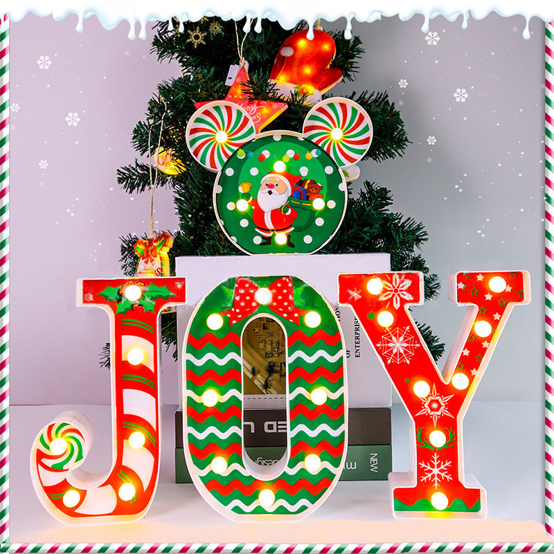 Illuminated JOY Christmas letters glowing warmly