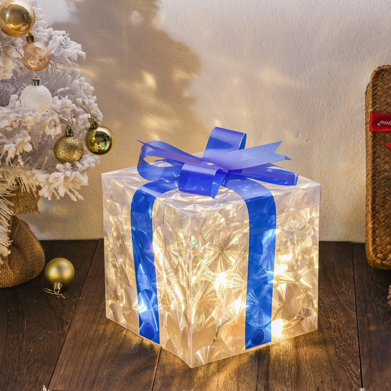 Christmas gift box decoration with glowing cat's eye effect in red and green tones