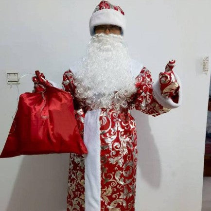 Christmas outfit costume components including hat beard and gloves laid out flat