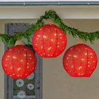 Green round lantern Christmas pendant with warm glowing appearance for holiday display