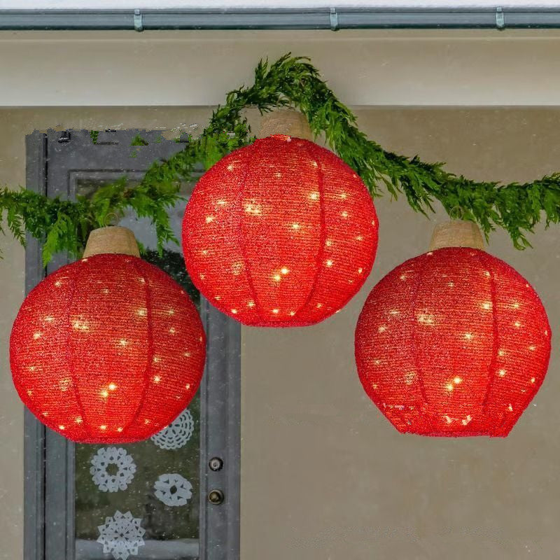 Green round lantern Christmas pendant with warm glowing appearance for holiday display