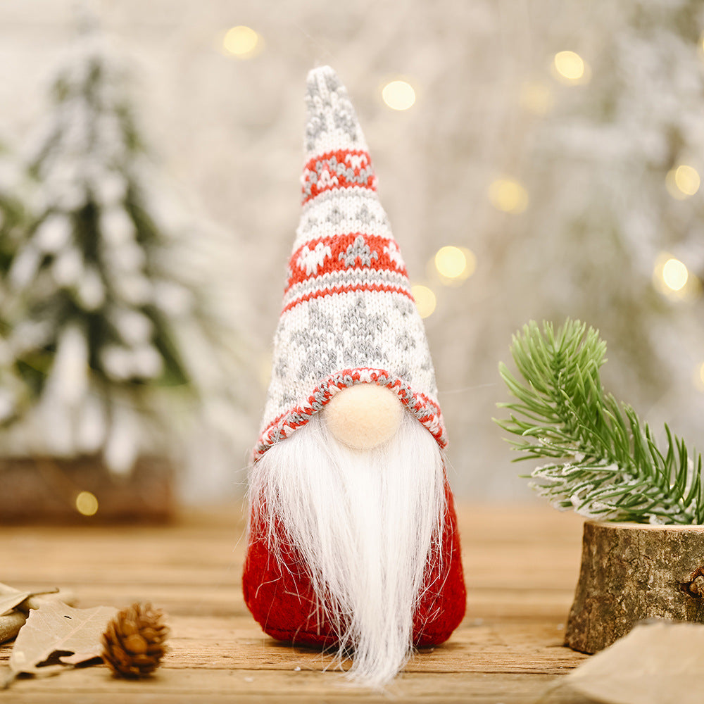 Three forest doll ornament variants with snowflake knitted hats in cozy woodland setting