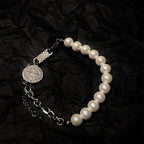 Elegant faith bracelet with crown and cross elements on display