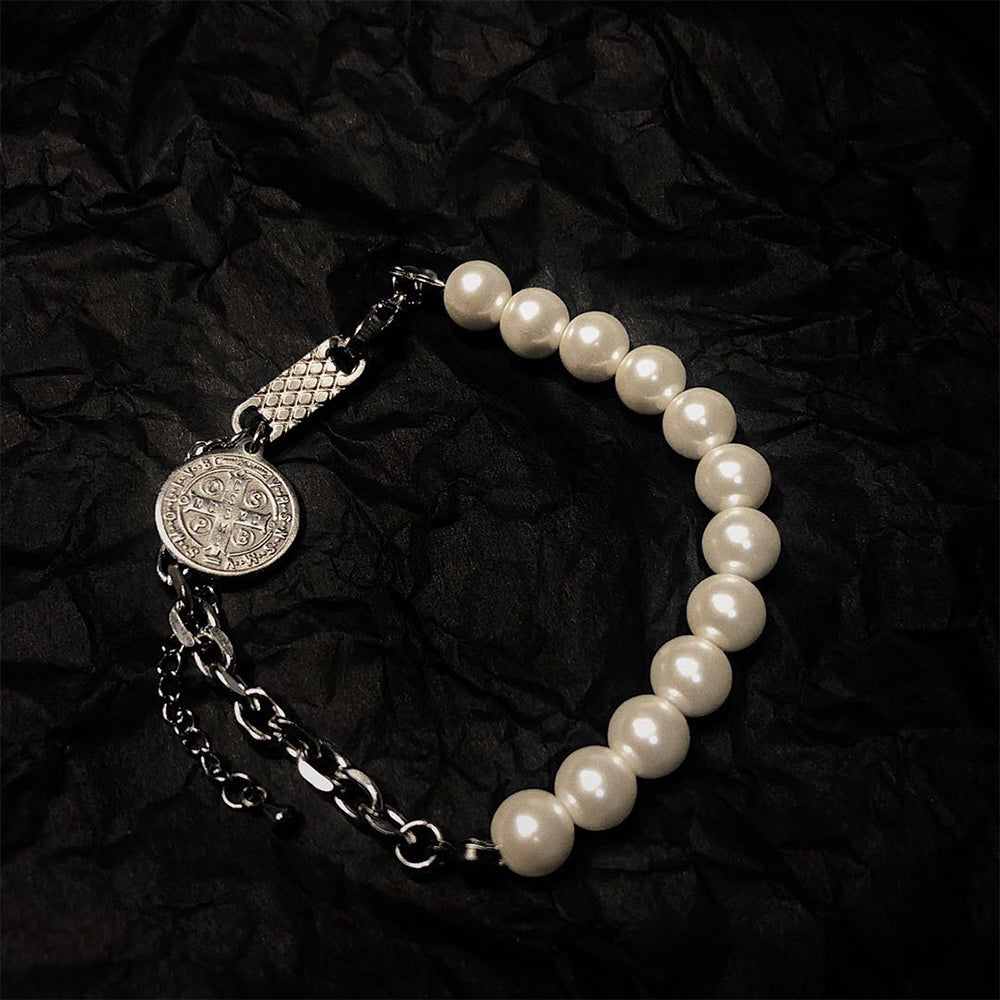 Elegant faith bracelet with crown and cross elements on display