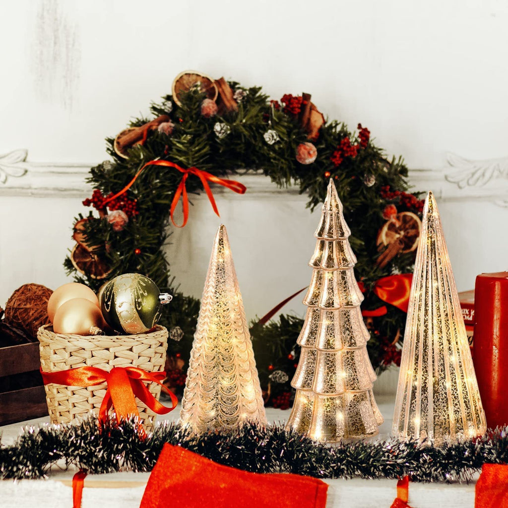Elegant glass Christmas ornament light crowned at the peak of a decorated tree