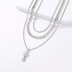 Layered Cuban chain necklace with geometric cross pendant in silver-tone