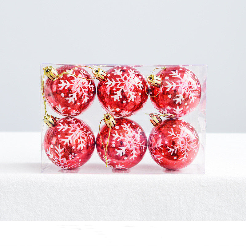Painted snowflakes on pink Christmas ornament ball for Christmas tree holiday display