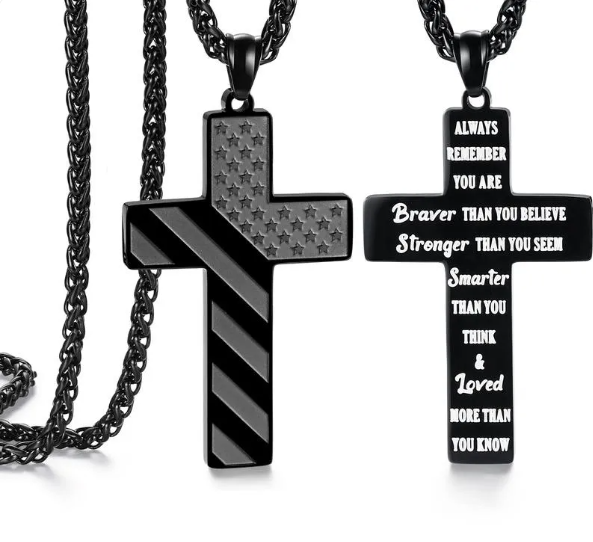 Close-up view of scripture inscription on patriotic cross necklace