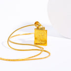 Close-up of geometric cross pendant in gold finish
