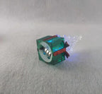 Green Christmas tree ornament with warm holiday tones