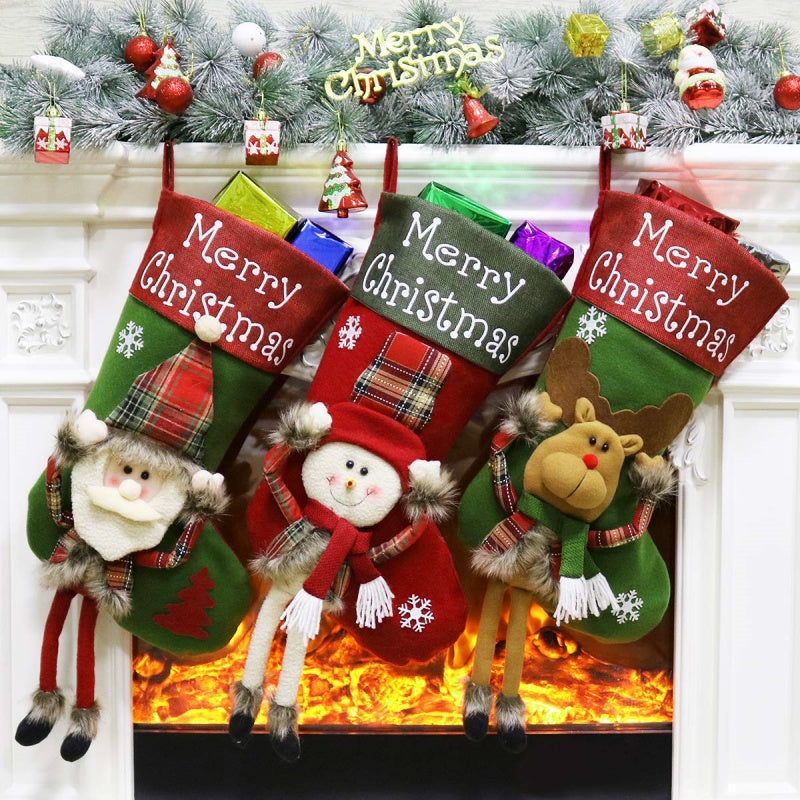 Colorful trio of Christmas stockings - Santa, Snowman, Reindeer - displaying together for holiday family decorating