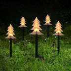 Set of snowflake garden lights installed along outdoor pathway at night