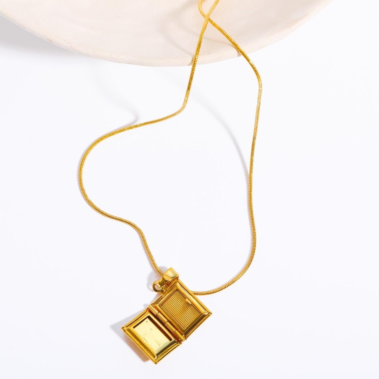 Gold cross pendant necklace on snake chain with photo box detail Main image