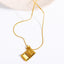 Gold cross pendant necklace on snake chain with photo box detail