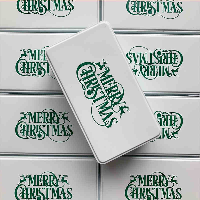 Green Christmas cookie box with gold pattern details and holly decoration