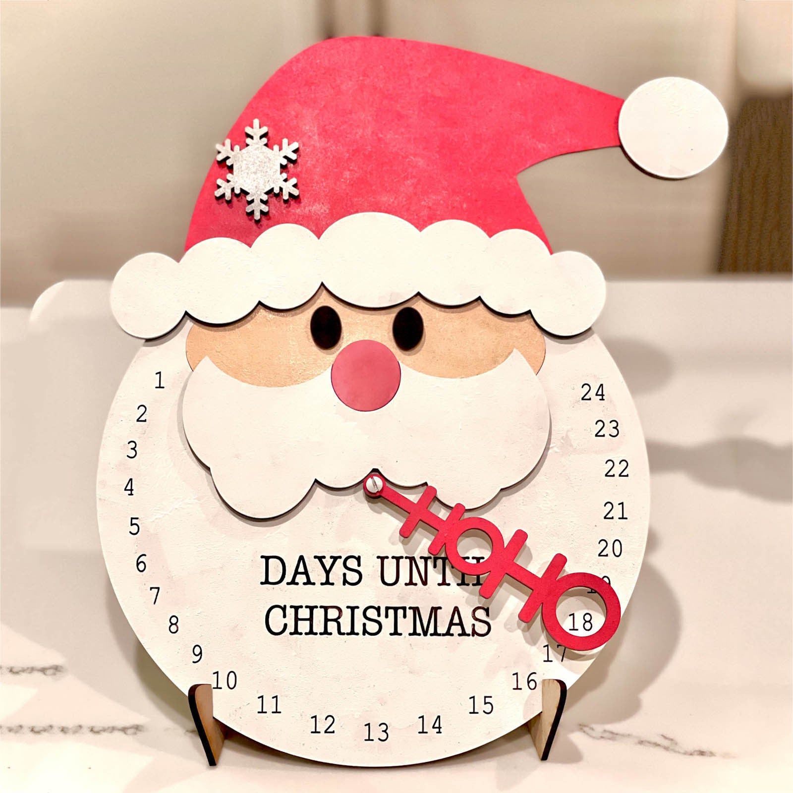 Set of wooden Christmas countdown ornaments with holiday greenery