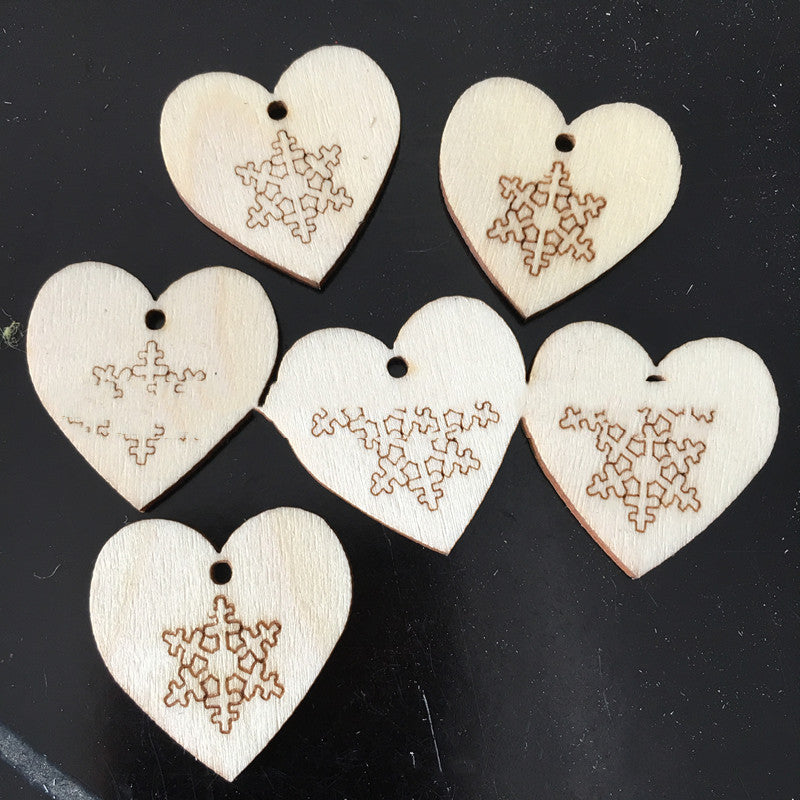 Detailed view of laser-cut wooden Christmas pendant with polished surface
