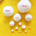 Elegant white Christmas ball ornament set against dark background