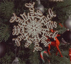 Close-up view of wooden Christmas pendant featuring snowflake and letter shape motif with double-layer depth