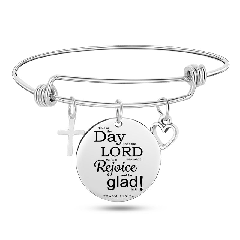 Polished silver religious bangle with devotional pendant detail