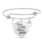 Polished silver religious bangle with devotional pendant detail