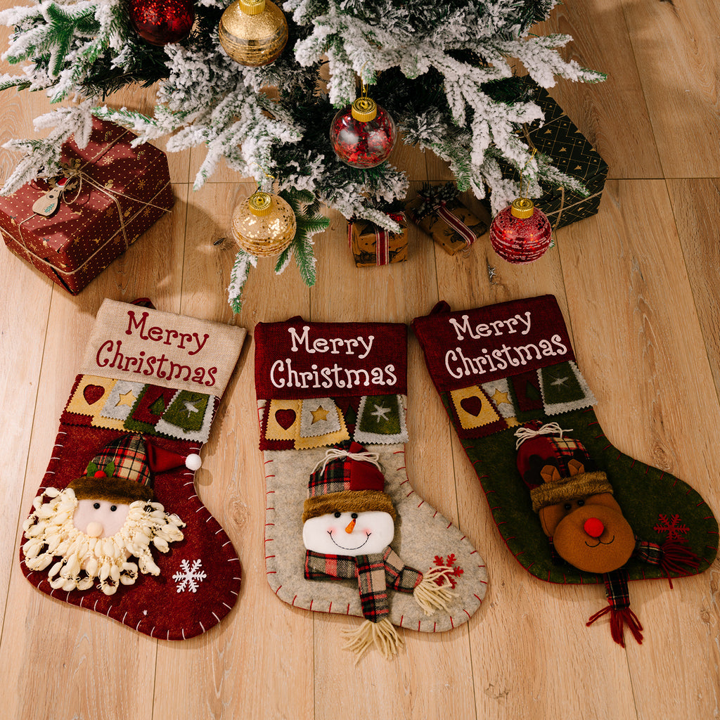 Christmas stocking pendant displayed on decorated tree branch
