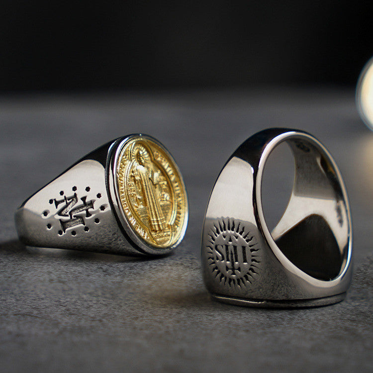 Close-up of the St. Benedict medal design on a titanium steel and copper men's ring