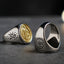Close-up of the St. Benedict medal design on a titanium steel and copper men's ring