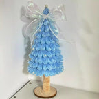 Small Christmas tree displaying luminous bow variant