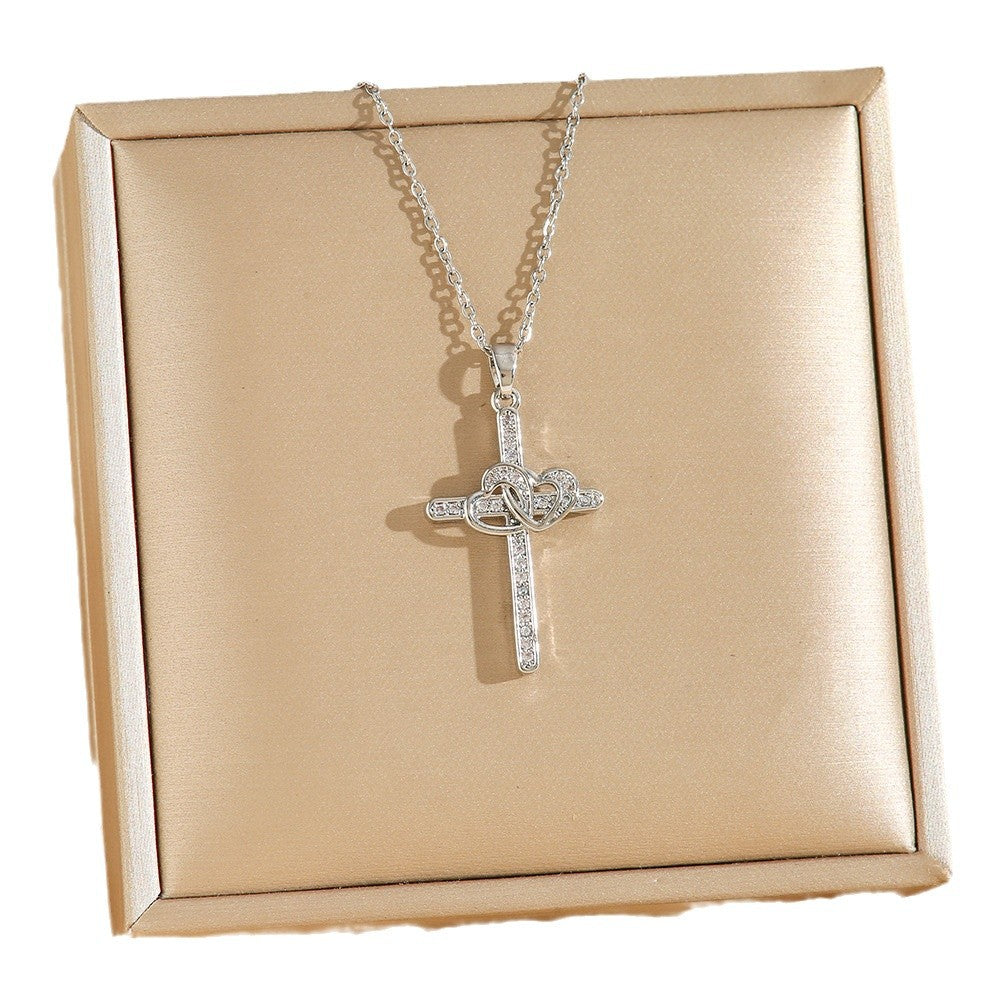 Stylized view of the gold-tone cross heart necklace
