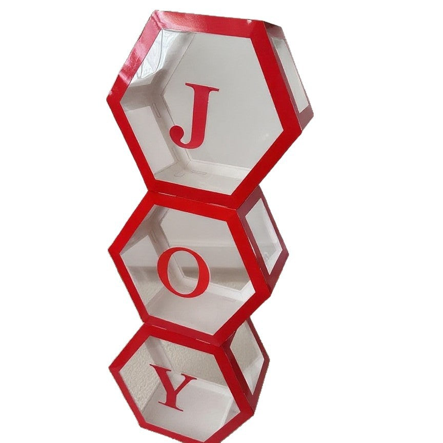 Set of paper hexagonal balloon boxes with Joy and Christmas lettering on festive red background