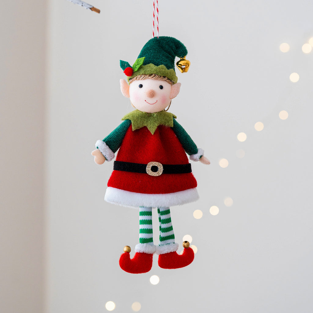 Boy elf doll pendant displayed on Christmas tree, festive holiday ornament