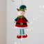 Boy elf doll pendant displayed on Christmas tree, festive holiday ornament