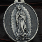 Close-up of Virgin Mary image on round pendant tag with gem inlay