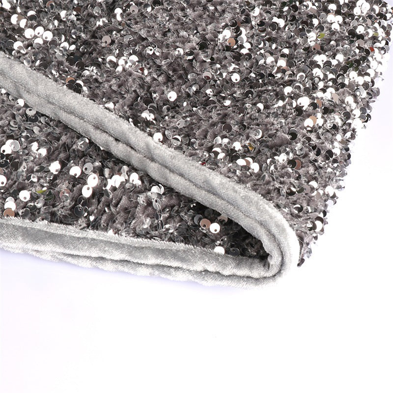 Close-up view of shimmering silver gray sequins on festive tree skirt