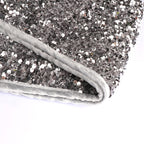 Close-up view of shimmering silver gray sequins on festive tree skirt