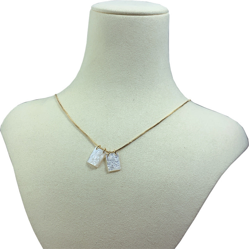 White religious necklace with mother pearl shell pendant detail