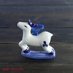 Classic blue and white porcelain ornament against festive green branches