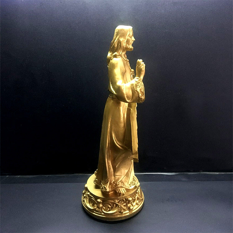 Close-up of luminous gold finish on Catholic devotional sculpture