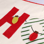 Faith-inspired Christmas tree skirt with decorative letters and trim