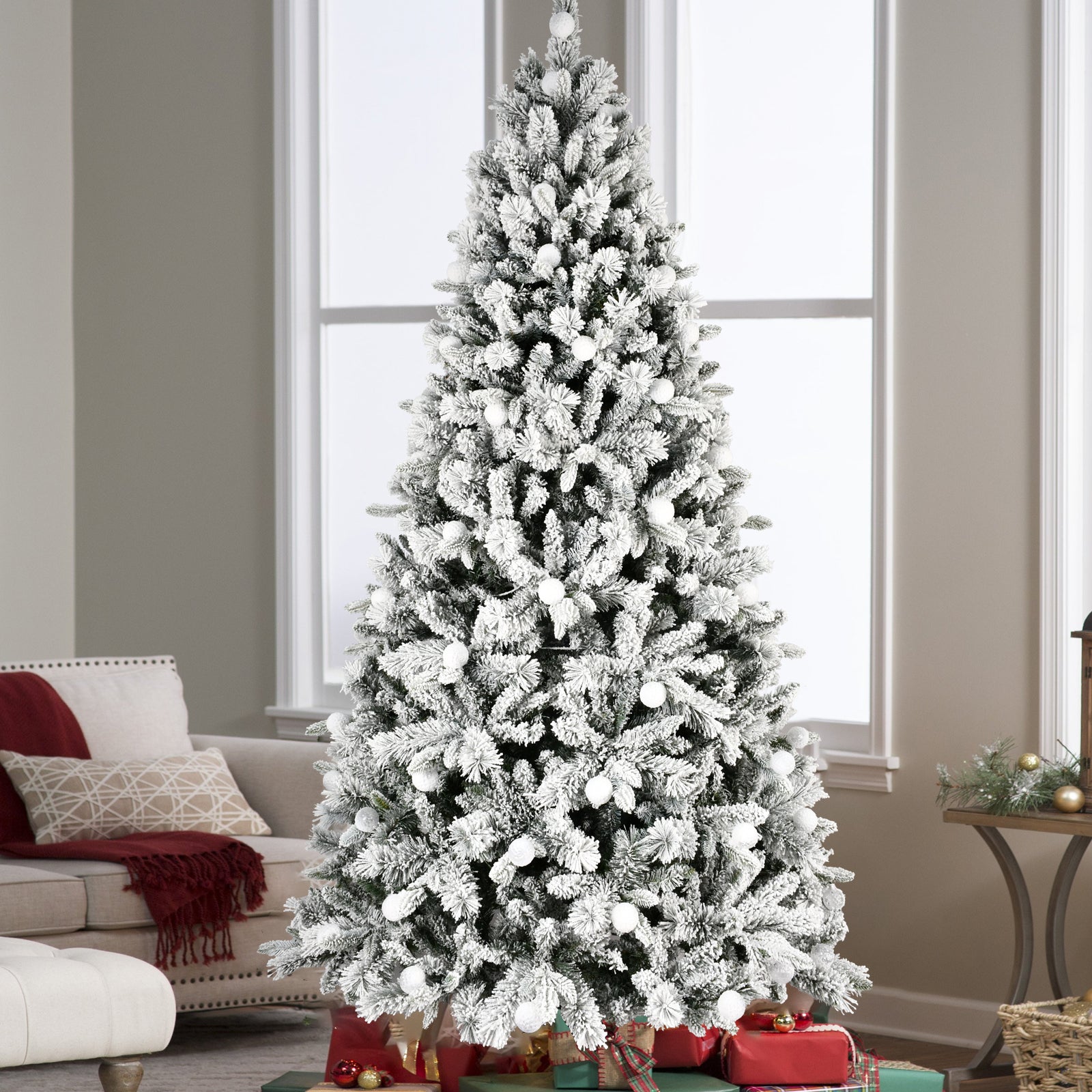 Fully decorated Christmas tree with lights and ornaments in home setting