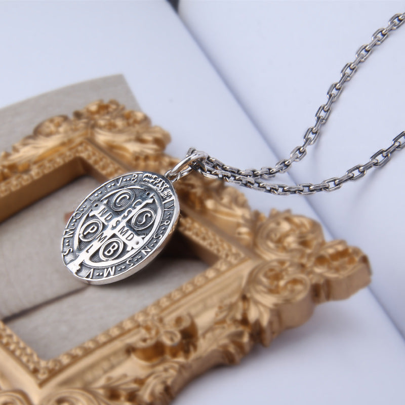 Sterling silver pendant resting elegantly on soft fabric showcasing its classic appeal