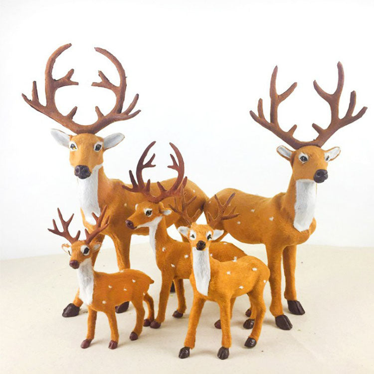 Flocked deer ornament with realistic antlers on wooden surface