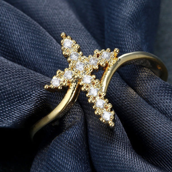 Diamond cross ring in gold tone showcasing polished surface