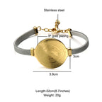 Close-up view of Saint Benedict medal centerpiece on golden bracelet