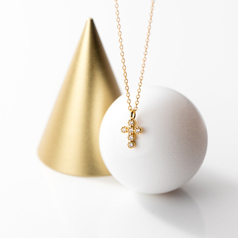 Gold-plated cross necklace detail view