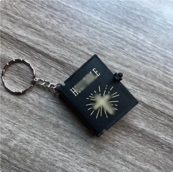 Close detail of cross pendant with Bible verse inscription